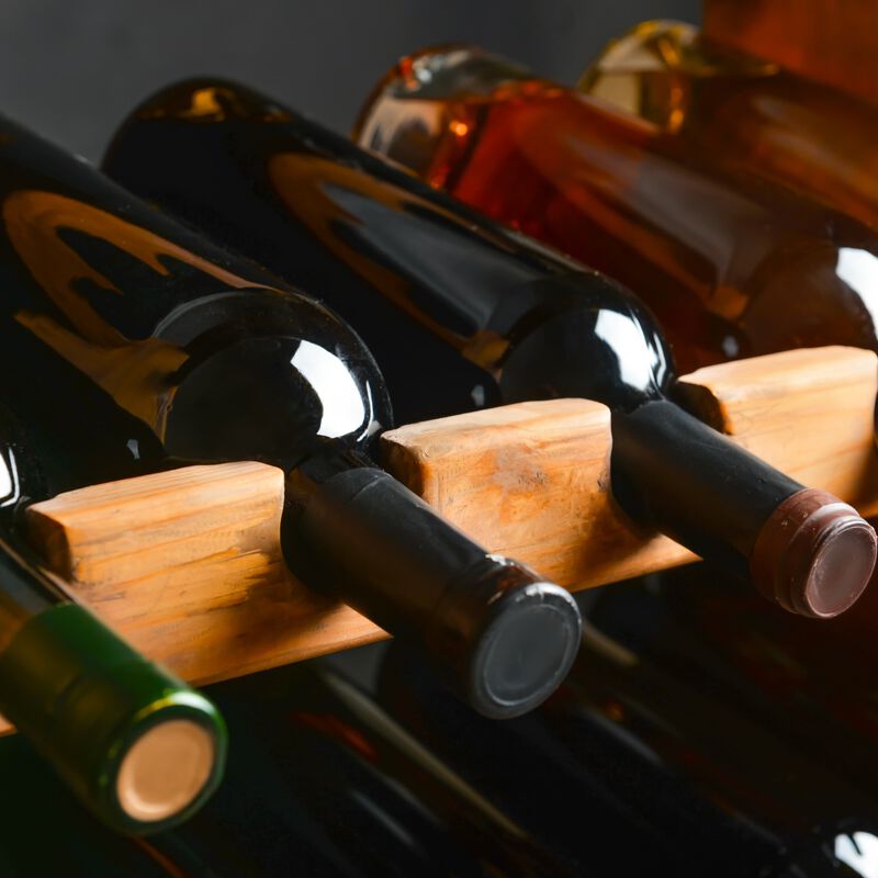 bottles of wine displayed on a wood wine rack